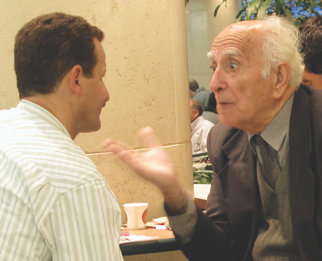 Two men share stories in a cafe. Photo: Alla Podolsky.