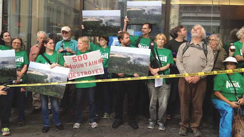 Members of Earth Quaker Action Team protest outside a PNC Bank in Manhattan.