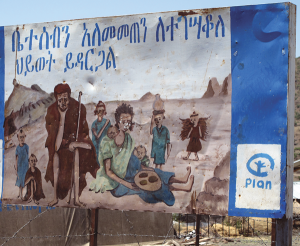 A family planning placard seen near Lalibela, Ethiopia. It shows some negative effects of having too many children (poverty, malnourishment, illnesses, insufficient education, deforestation, desertification).