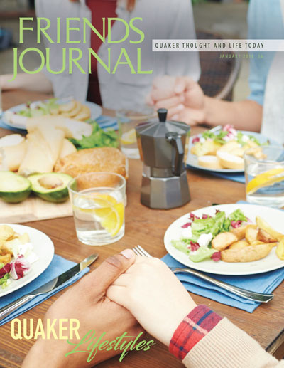 Cover of January issue: people holding hands around a table full of healthy food.
