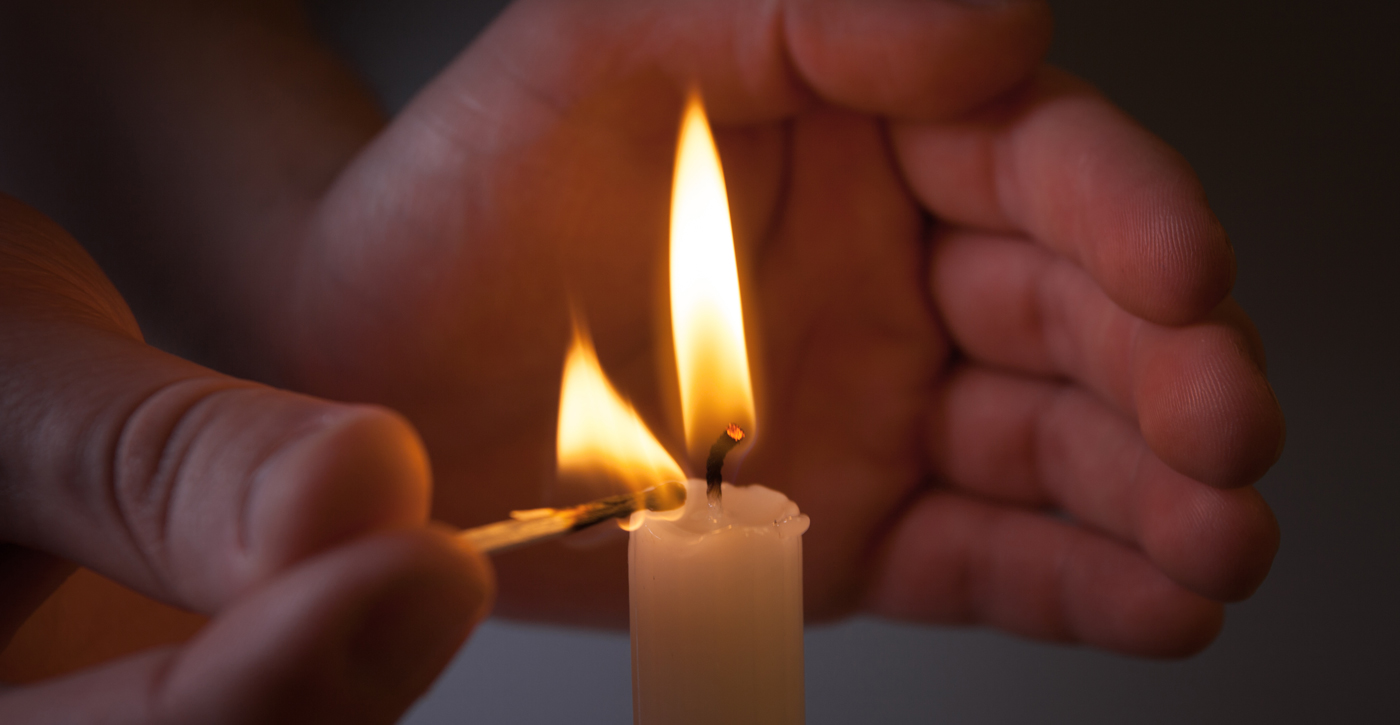 Candle lit by match